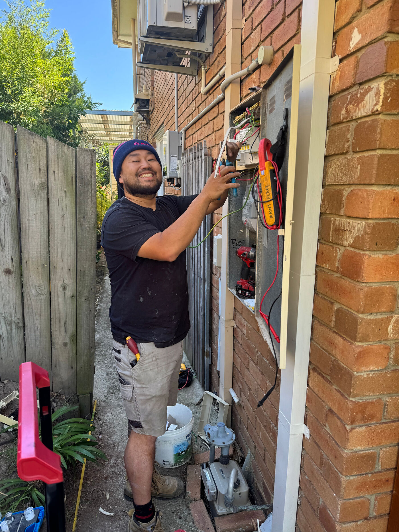 Jimmy smiling while working at an outdoor meter box